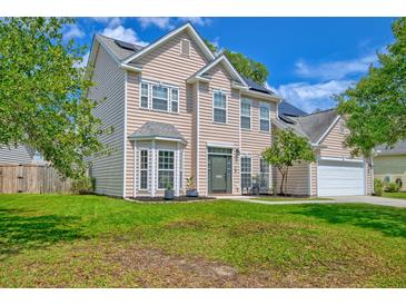 Charming two-story home with lush green lawn and traditional architectural details at 9682 Pebble Creek Blvd, Summerville, SC 29485