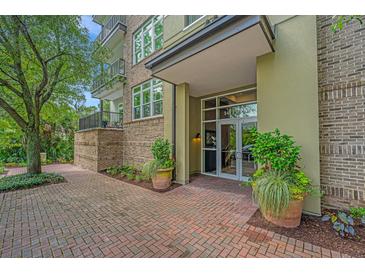 Inviting entrance with well-maintained brick walkway and tasteful landscaping enhancing the building's curb appeal at 145 Pier View St # 214, Daniel Island, SC 29492