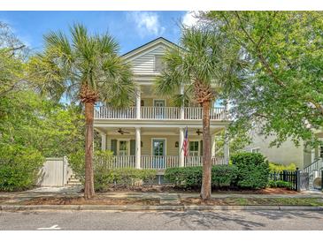 Charming two-story home with double porches framed by beautiful palm trees, embodying Southern charm at 183 Civitas St, Mount Pleasant, SC 29464