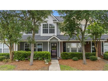 Charming townhouse featuring a well-kept lawn, lush bushes, and welcoming entrance at 402 Pine Bluff Dr, Summerville, SC 29483