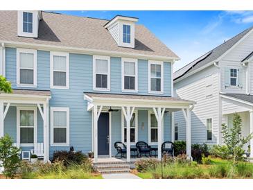 Charming blue two-story home with a inviting front porch, perfect for relaxing and enjoying the neighborhood at 557 Blueway Ave, Summerville, SC 29486