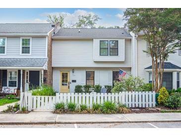 Charming townhome with a white picket fence and well-maintained landscaping at 705 Williamson Dr # C, Mount Pleasant, SC 29464