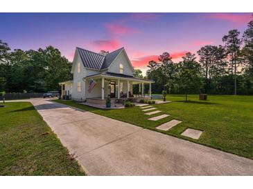 Beautiful two-story home with a large front yard and a charming porch at 810 Highway 61, Ridgeville, SC 29472