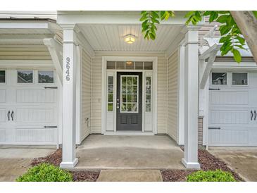 Welcoming front entrance with a black door, sidelights, and a covered porch at 9646 Scarborough Ct, Summerville, SC 29485