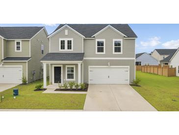 Charming two-story home with gray siding, a white garage door, and a well-manicured lawn at 105 Oast Ln, Summerville, SC 29485