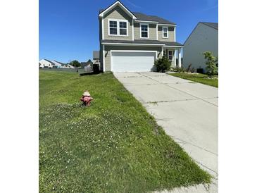 Charming two-story home featuring a two-car garage, manicured lawn, and classic architectural design at 1343 Discovery Dr, Ladson, SC 29456