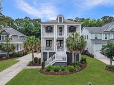 Charming two-story home with double front porches, landscaped yard, and palm trees at 1489 Red Tide Rd, Mount Pleasant, SC 29466
