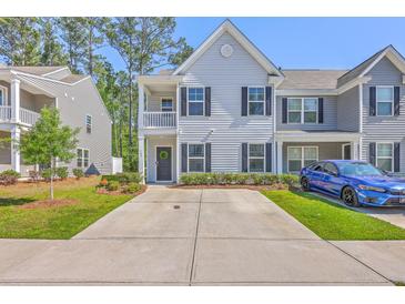 Charming two-story townhome with a welcoming entrance and a long driveway at 163 Spencer Cir, Summerville, SC 29485