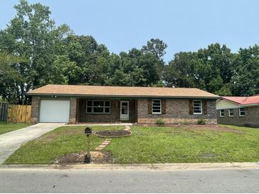 Charming brick home with a well-manicured lawn and a classic mailbox at 2 Clarksville Ln, Goose Creek, SC 29445