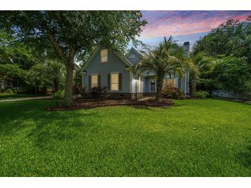 Charming two-story home with lush landscaping, mature trees, and beautiful lawn at 2031 Thornhill Dr, Summerville, SC 29485