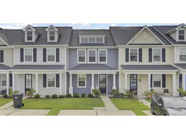 Charming townhome with a well-manicured lawn and covered front porch, perfect for relaxing outdoors at 208 Kirkland St, Goose Creek, SC 29445