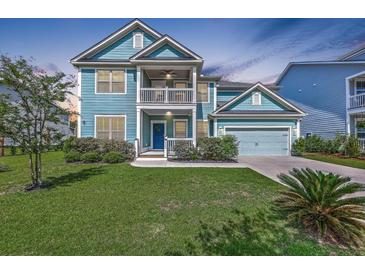 Charming two-story home featuring a double porch, blue siding, well-manicured lawn, and an attached two-car garage at 2336 Brinkley Rd, Johns Island, SC 29455