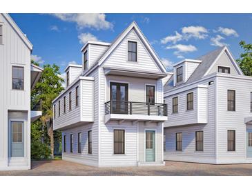 Charming new construction home featuring a balcony, painted siding and a welcoming entrance, ideal for coastal living at 25 Nats Ct, Charleston, SC 29403