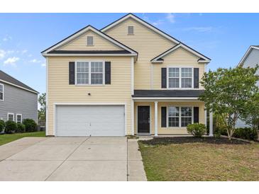 Charming two-story home featuring a classic design, attached garage and manicured landscaping at 251 Emerald Isle Dr, Moncks Corner, SC 29461