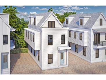 Charming three-story beach house with white siding, a small porch, and light-blue door at 26 Nats Ct, Charleston, SC 29403
