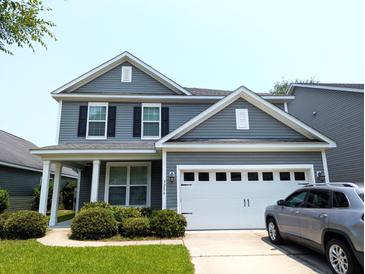 Charming two-story home with gray siding, a two-car garage, and well-maintained landscaping at 3254 Hartwell St, Johns Island, SC 29455