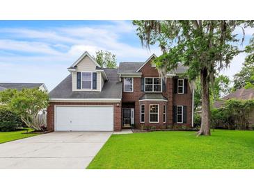 Charming two-story brick home featuring a well-manicured lawn and mature tree, offering classic curb appeal at 3290 Middleburry Ln, Charleston, SC 29414