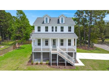 Charming two-story coastal home with a welcoming front porch and manicured lawn at 1577 Periwinkle Dr, Mount Pleasant, SC 29466