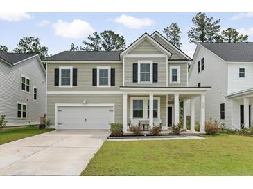 Charming two-story home with a well-manicured lawn and a welcoming front porch at 174 Red Bluff St, Summerville, SC 29483