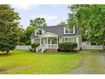 Charming cape cod with dormers, white picket fence, mature landscaping at 19 Avondale Ave, Charleston, SC 29407