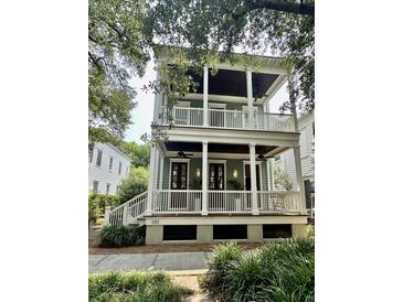 Charming two-story home with double porches, white railings, and a well-manicured lawn at 190 Ionsborough St, Mount Pleasant, SC 29464