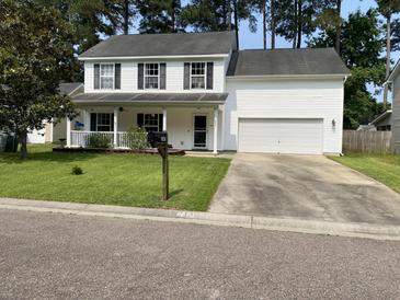 Charming two-story home with white siding, black shutters, well-maintained lawn, and attached garage at 243 Trickle Dr, Summerville, SC 29483