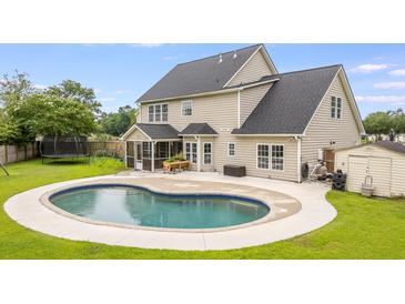 Inviting backyard with a beautiful pool and well-maintained lawn, perfect for outdoor enjoyment at 5289 Mulholland Dr, Summerville, SC 29485