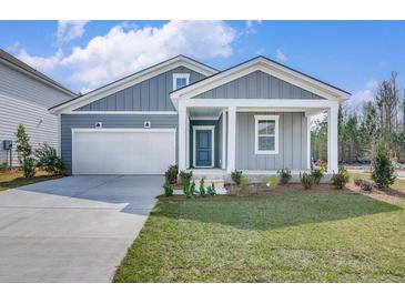 Charming home with gray siding, white trim, inviting front porch, and a well-maintained front lawn at 778 Meadowbrook Ln, Summerville, SC 29486