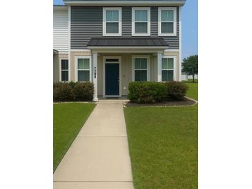 Inviting two-story home with a charming entrance and well-maintained landscaping, offering a warm and welcoming curb appeal at 7788 Montview Rd, North Charleston, SC 29418