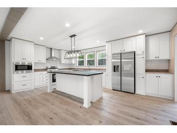Bright, modern kitchen features stainless steel appliances, an island and white cabinetry at 106 Swanson Dr, Summerville, SC 29483