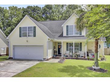 Charming two-story home with a well-manicured lawn and inviting front porch with seating at 172 Cotillion Cresent Cres, Summerville, SC 29483