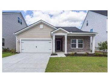 Charming single-story home featuring a one-car garage, inviting entrance, and well-manicured lawn at 206 Camellia Bloom Dr, Moncks Corner, SC 29461