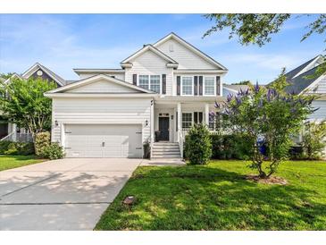 Charming two-story home with a well-manicured lawn, a two car garage and inviting front porch at 2152 Pentland Dr, Charleston, SC 29412