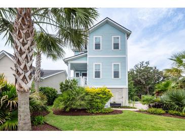 Charming, light blue two-story home with landscaped yard and a lush tropical palm tree in the front at 2734 Battle Trail Dr, Johns Island, SC 29455