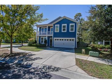 Charming blue two-story home featuring a spacious driveway and a welcoming double porch at 3306 Hartwell St, Johns Island, SC 29455
