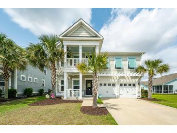 Charming home with a two-story porch, well-manicured lawn, and beautiful palm trees at 415 True North Trail, Summerville, SC 29486