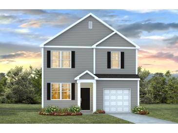 Charming two-story home with gray siding, black shutters, and a well-manicured lawn at 8021 Rackham Rd, Hollywood, SC 29470