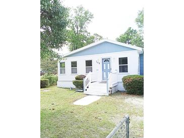 Charming single-story home with a blue door, white trim, and a well-maintained front yard at 104 Grant St, Walterboro, SC 29488