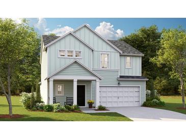 Charming two-story home with light green siding, white trim, covered porch, attached garage, and manicured lawn at 119 Lefton Lndg, Summerville, SC 29485