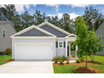 Charming one-story home features a gray exterior, attached garage, and a well-manicured lawn at 139 Sunray Ln, Summerville, SC 29486
