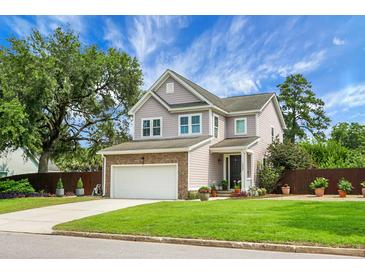 Charming two-story home featuring a brick-accented garage, beautiful lawn, and a manicured front yard at 1422 Iroquois St, North Charleston, SC 29405