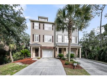 Charming townhome exterior featuring a private driveway and manicured landscaping with mature palm trees at 160 Palm Cove Way, Mount Pleasant, SC 29466