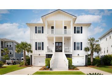 Stunning two-story white home with black shutters, double garages, palm trees and beautiful lawn at 1714 Fort Palmetto Cir, Mount Pleasant, SC 29466