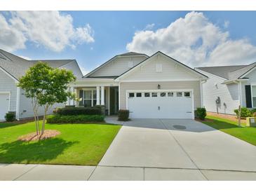 Charming one-story home with a two-car garage, lush landscaping, and well-maintained lawn in a quiet neighborhood at 344 Seaside Trl, Summerville, SC 29486