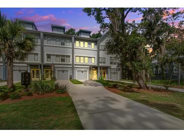 Charming townhomes featuring a driveway and gray siding, creating a welcoming and modern curb appeal at 4067 S Rhett Ave, North Charleston, SC 29405