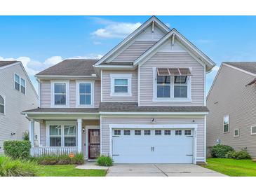 Charming two-story home with a well-manicured lawn and an attached two-car garage at 531 Crossland Dr, Moncks Corner, SC 29461