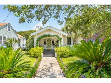 Charming cottage-style home with a landscaped front yard and a cozy, inviting entrance at 66 Darlington Ave, Charleston, SC 29403