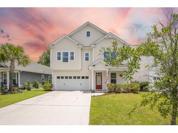 Charming two-story home features a red front door, manicured lawn, and attached two-car garage at 106 Sago Ct, Summerville, SC 29486