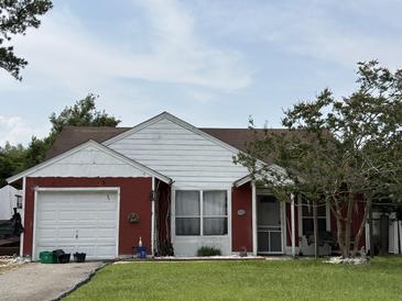 Charming single-story home with attached garage and inviting front porch swing at 107 Tabby Creek Cir, Summerville, SC 29486