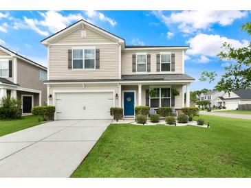 Charming two-story home with a well-manicured lawn, blue front door, and an attached two-car garage at 1301 Wild Goose Trl, Summerville, SC 29483